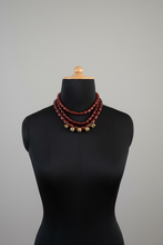 Load image into Gallery viewer, Mannequin wearing a brown beaded necklace with gold accents against a neutral background